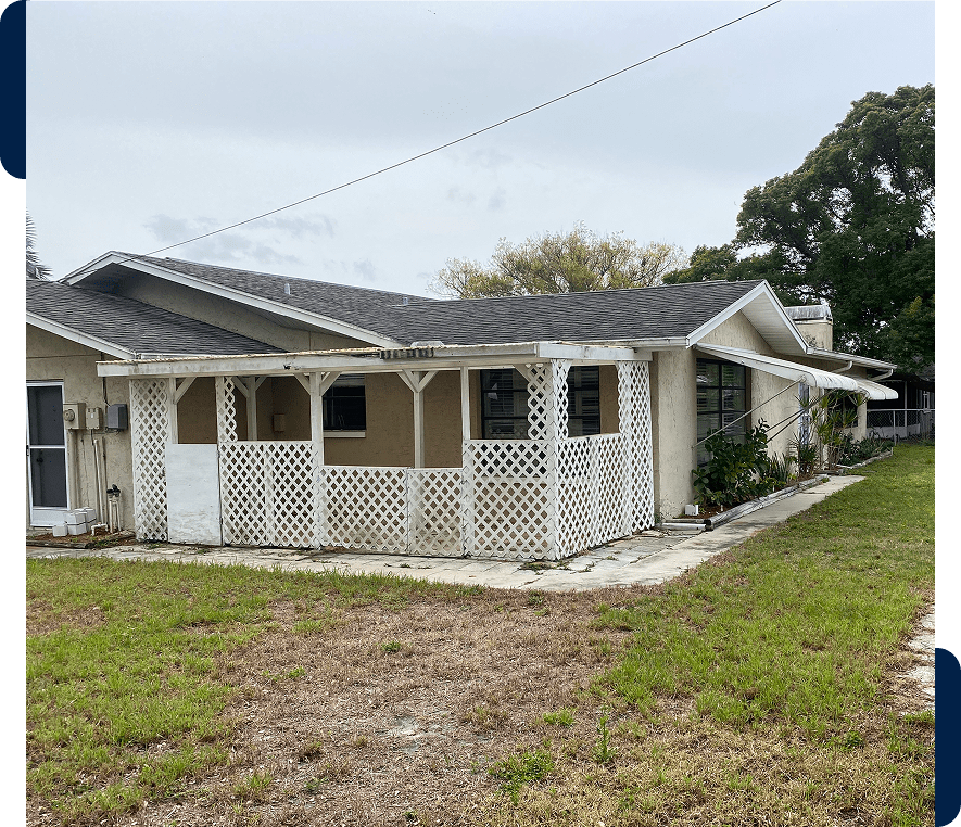 Single-story house with white lattice porch.